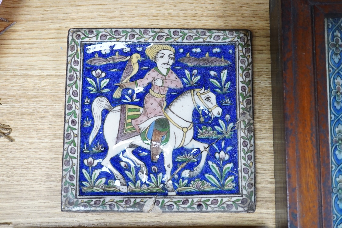 Four 18th/19th century Persian tiles, two depicting horses and riders and abstract flowers, three framed, largest 40 x 21cm